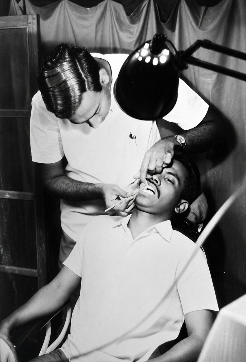 Dr. Rajendran treating patients in the early years of the clinic